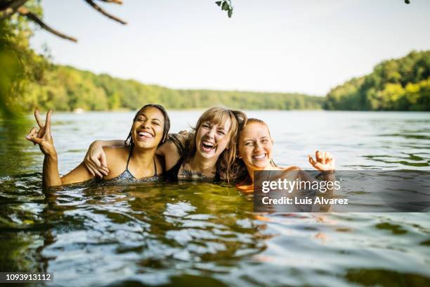 portrait of three young women together in lake - alleen jonge vrouwen stockfoto's en -beelden