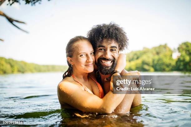 beautiful young couple together in lake - portrait playful caucasian man foto e immagini stock