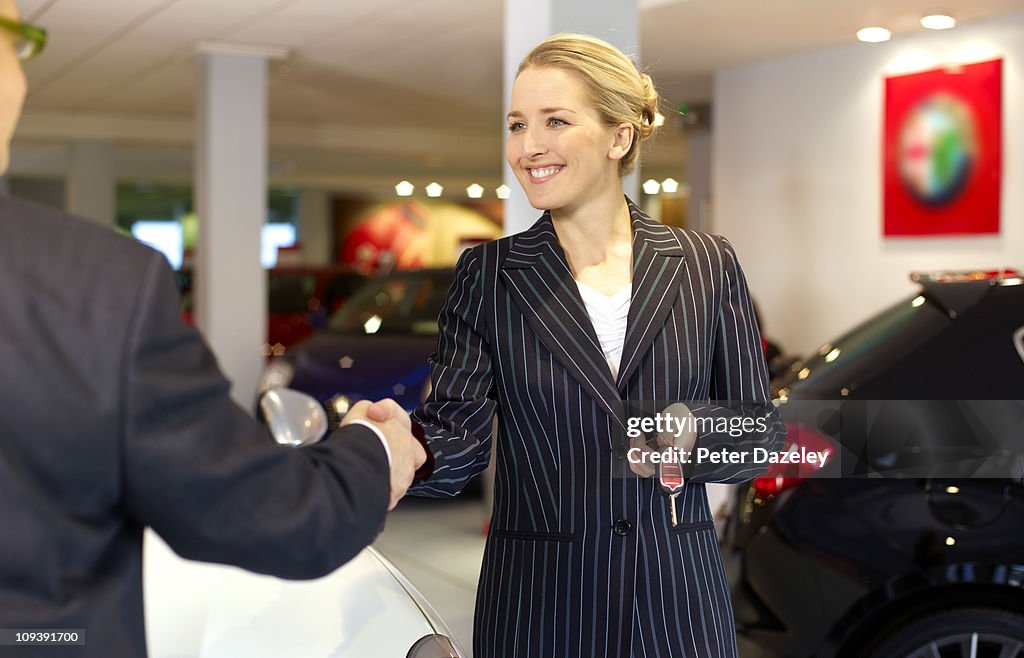 Car saleswoman selling car