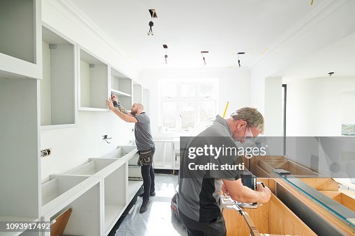 Joinery team fitting a kitchen Joinery team fitting a kitchen