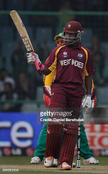 Darren Bravo of West Indies raises his bat on scoring his half century during the 2011 ICC World Cup Group B match between West Indies and South...