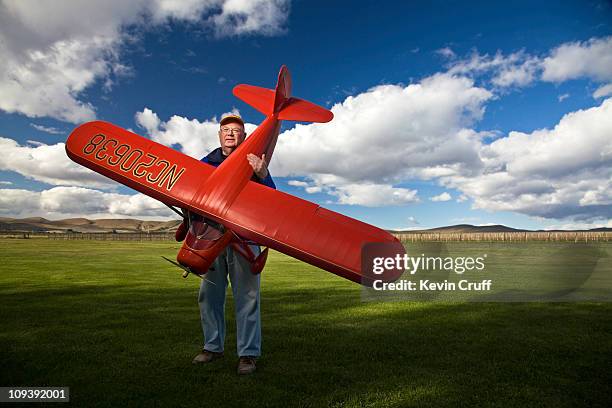 man holding model plane - toy airplane stock-fotos und bilder