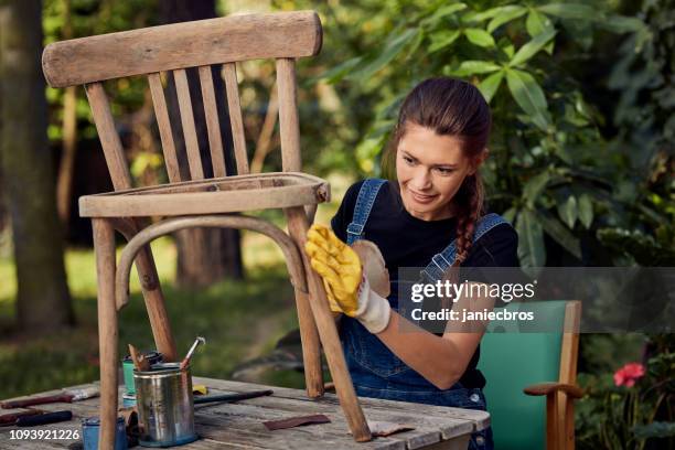 diy in the garden. grinding wooden chair - woman diy stock pictures, royalty-free photos & images