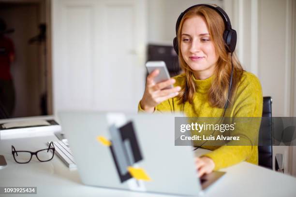 woman relaxing at home in free time - headphones woman stock-fotos und bilder