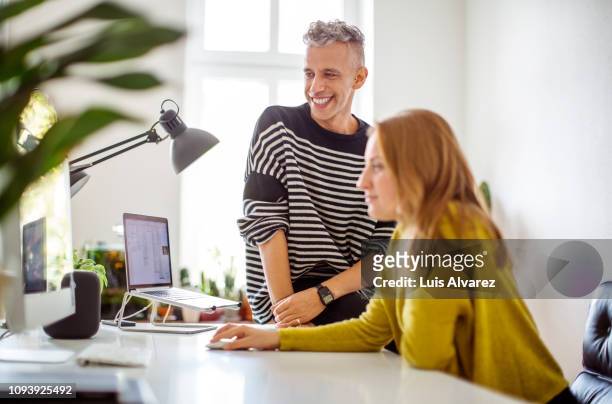 couple sitting at desk using computer at home - husband stock pictures, royalty-free photos & images