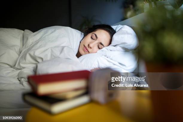 young woman sleeping peacefully - slapen stockfoto's en -beelden