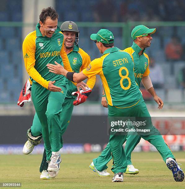 Johan Botha of South Africa celebrates the wicket of Chris Gayle of West Indies with Dale Steyn during the ICC Cricket World Cup match between South...