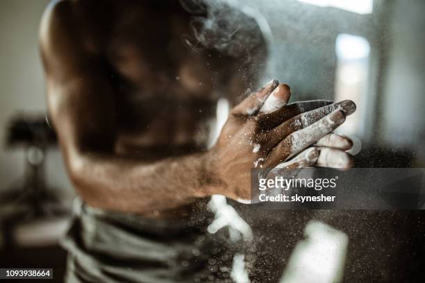 close up of unrecognizable athlete preparing his hands with powder. - sports chalk stock pictures, royalty-free photos & images