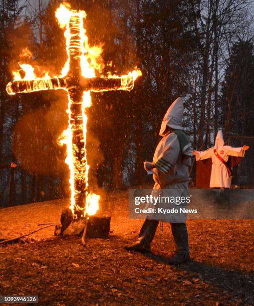 Members of a group called the Honorable Sacred Knights of the Ku Klux Klan burn a cross in the suburbs of Madison, Indiana, on Jan. 26, 2019. ==Kyodo