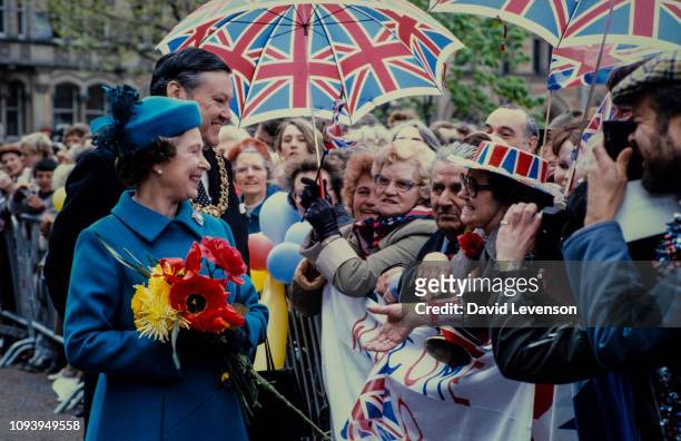 Queen Elizabeth II meets the crowd on a walkabout on May 4, 1982 in Albert Square, Manchester.