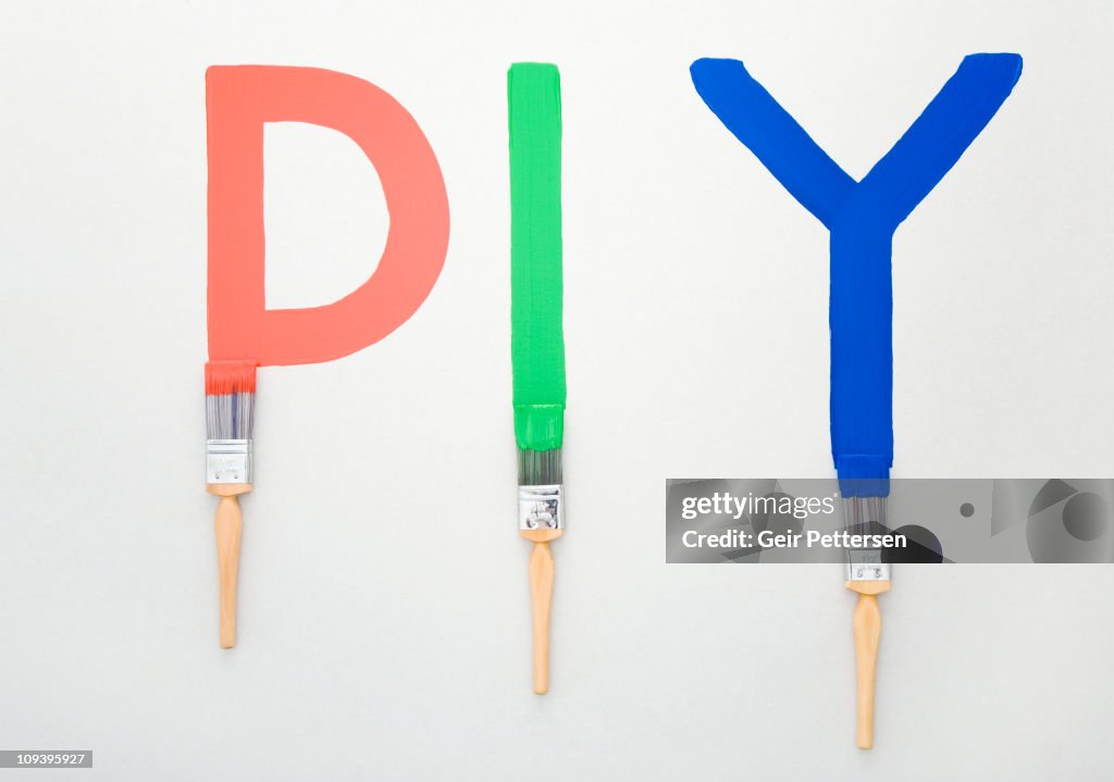 The letters DIY in red, green and blue paint