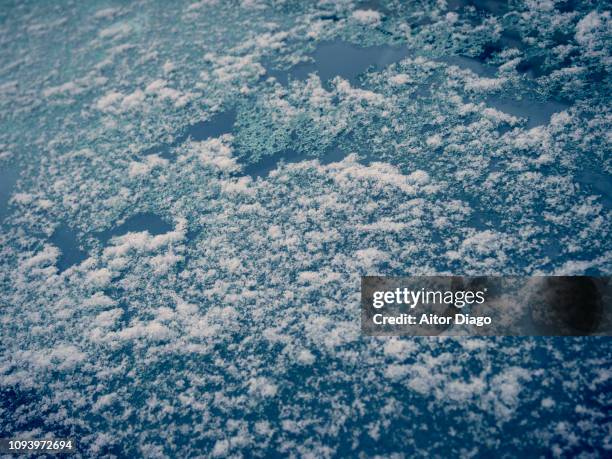 it seems to be a view of the earth from the sky but it is just ice on glass. conceptual nature - de ices stock pictures, royalty-free photos & images