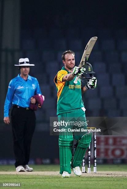 De Villiers of South Africa raises his bat after reaching his century during the 2011 ICC World Cup Group B match between West Indies and South...