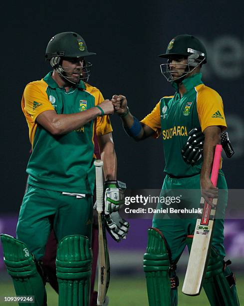 De Villiers of South Africa celebrates with team mate Jean-Paul Duminy aftertheir victory during the 2011 ICC World Cup Group B match between West...