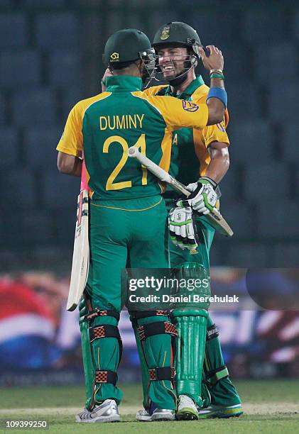 De Villiers of South Africa celebrates with team mate Jean-Paul Duminy on scoring the winning runs during the 2011 ICC World Cup Group B match...