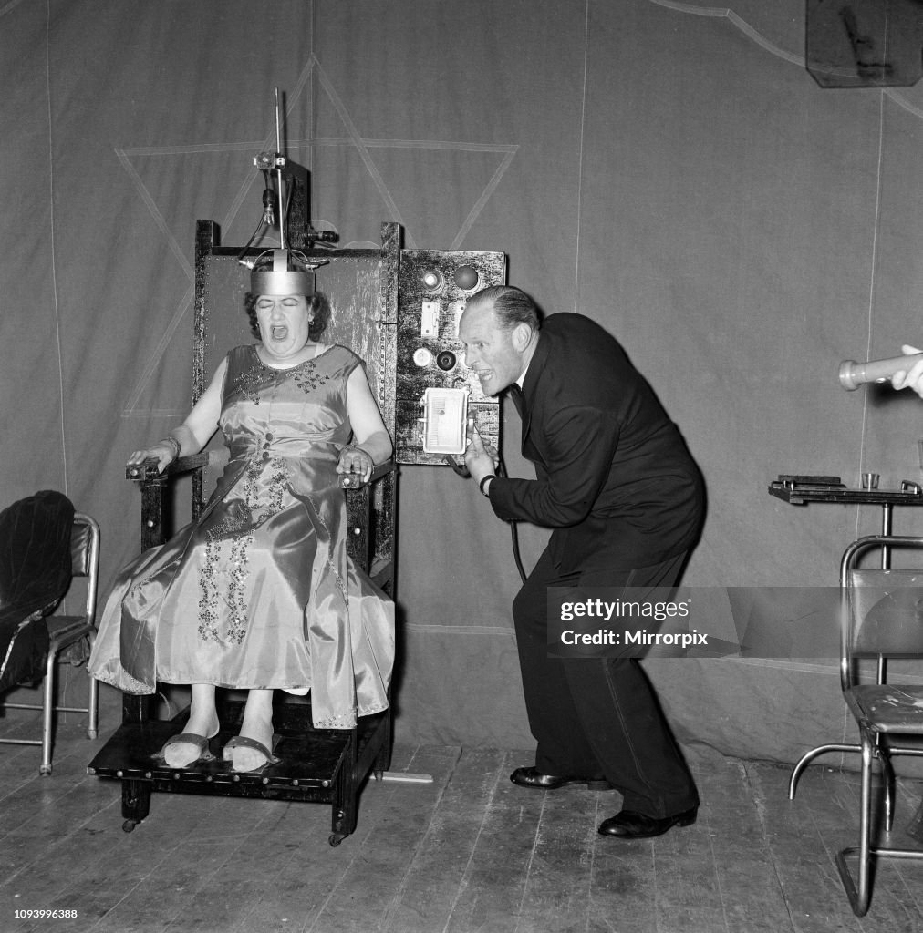 A man electrocuting his wife for a fairground sideshow, 1957
