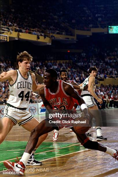 Michael Jordan of the Chicago Bulls dribbles against Danny Ainge of the Boston Celtics during Game 2 of the Eastern Conference quarterfinals during...