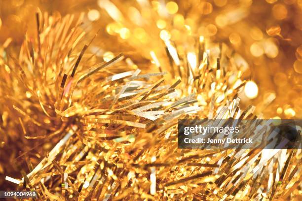 gold tinsel - tinsel stock pictures, royalty-free photos & images