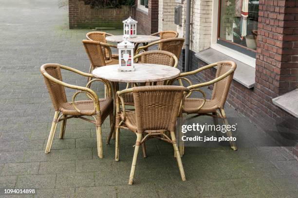 tables and chairs outside on the street next to a restaurant - coffee on patio stock pictures, royalty-free photos & images