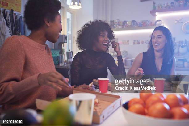 young women having party in the kitchen and eating pizza - luxury home dining table people lifestyle photography people stock pictures, royalty-free photos & images