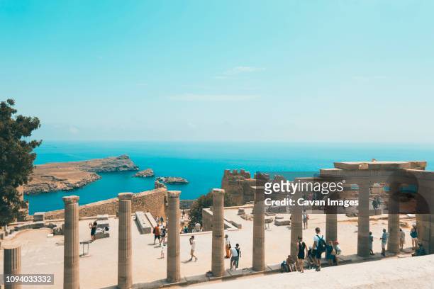 high angle view of tourists visiting archeological site against blue sky during sunny day - rhodes,_new_south_wales stock pictures, royalty-free photos & images