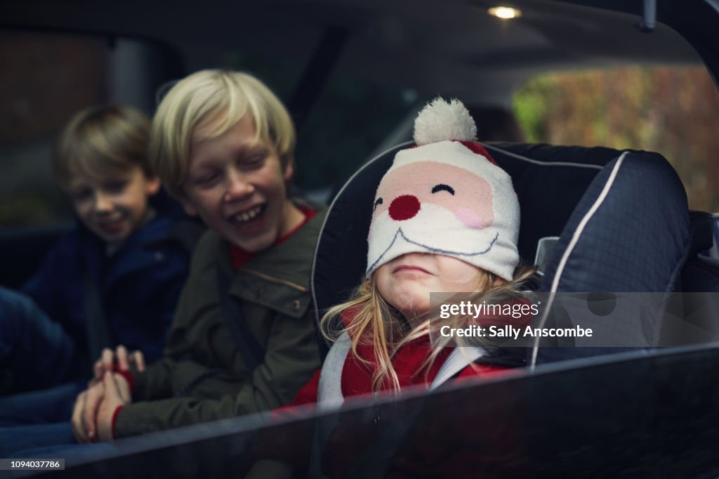 Children in the car going Christmas shopping
