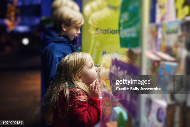 family going christmas shopping together - christmas toys stock pictures, royalty-free photos & images