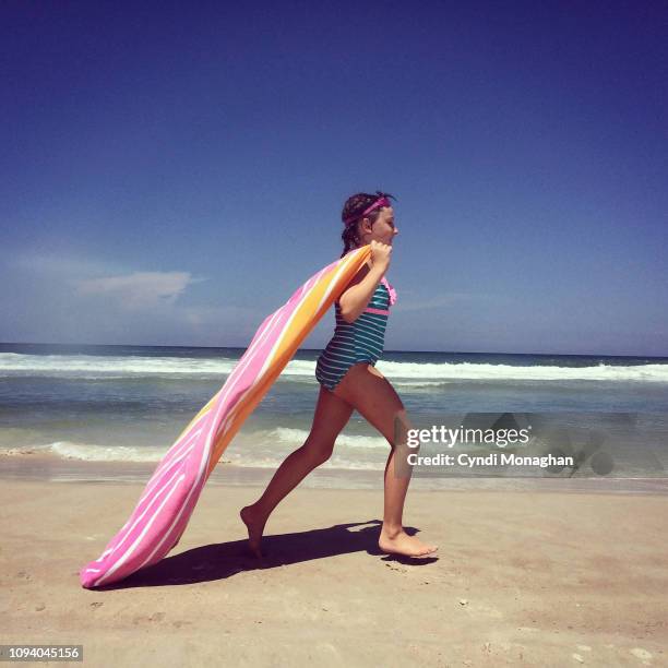 little girl in french braids running with a towel cape on the beach - summer super 8 stockfoto's en -beelden