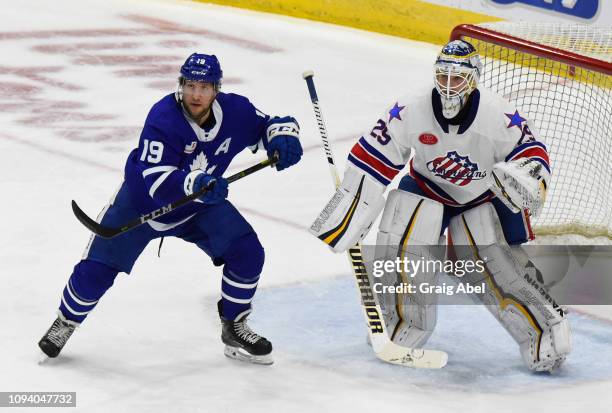 Chris Mueller of the Toronto Marlies and goalie Scott Wedgewood of the Rochester Americans prepare for a shot during AHL game action on January 12,...