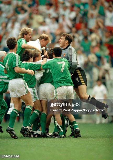 Republic of Ireland players celebrate with goalkeeper Packie Bonner after the 1990 FIFA World Cup 2nd Round match between the Republic of Ireland and...