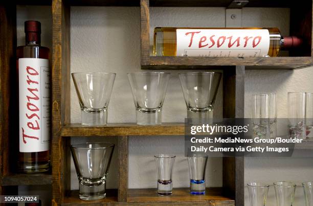 Bottles of hand crafted, small batch, rum are seen on a shelf in the tasting room, Thursday, Dec. 19 at the Tesouro Distillery in Longmont.