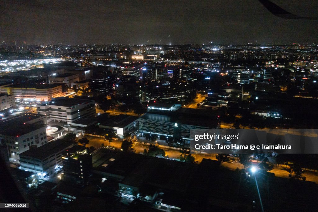 Suburb of Singapore city night time aerial view from airplane