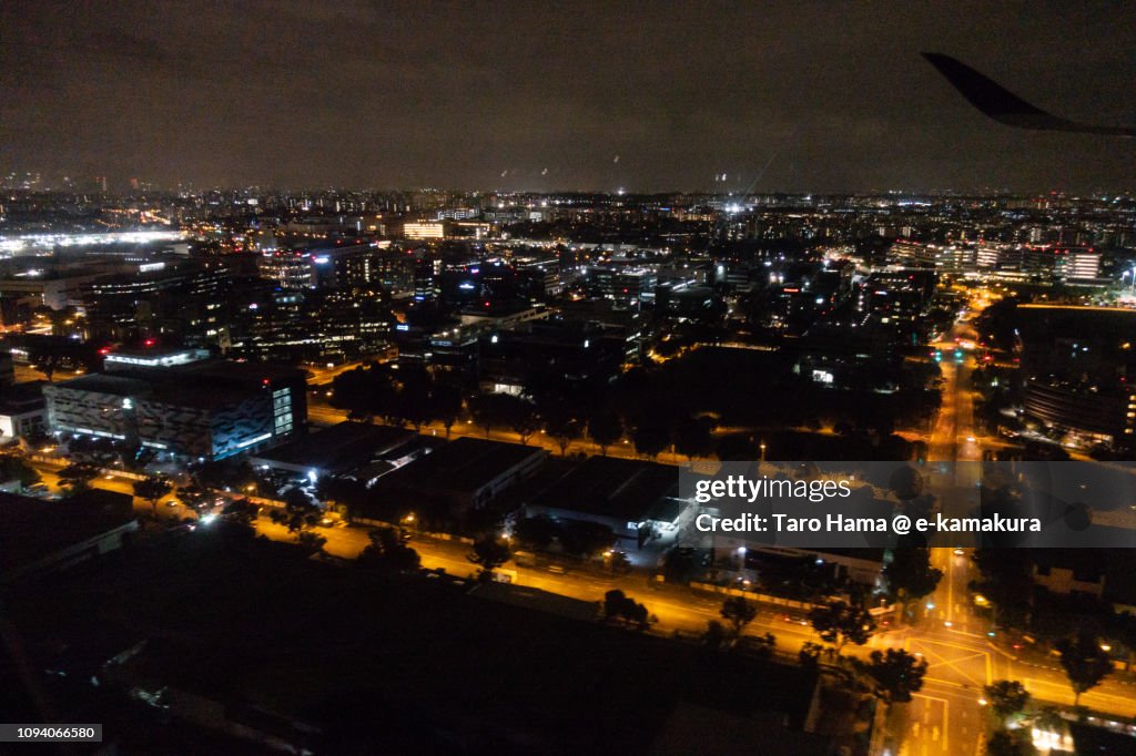 Suburb of Singapore city night time aerial view from airplane