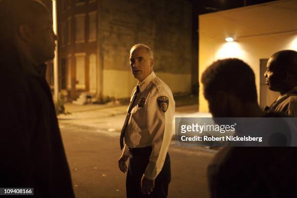 Baltimore Police Commissioner Fred Bealefeld lll, speaks with a juvenile, center right, who became belligerent with police in a variety store October...