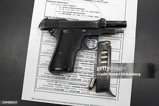 Baltimore Police display a 9mm Beretta handgun recovered from a male arrested for drug dealing October 19, 2010 in Baltimore, Maryland. Known as a...