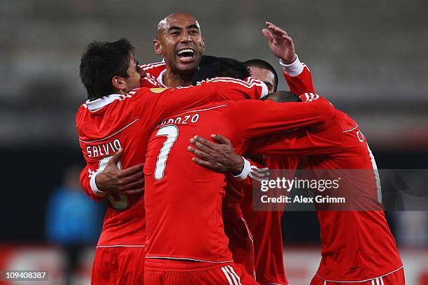 Oscar Cardozo of Benfica celebrates his team's second goal with team mates during the UEFA Europa League match round of 32 second leg between VfB...