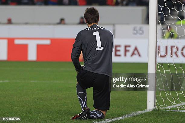 Goalkeeper Sven Ulreich of Stuttgart kneels on the pitch after Oscar Cardozo of Benfica scored his team's second goal during the UEFA Europa League...