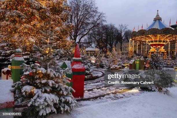 snowy christmas scene, tivoli gardens, copenhagen. - tivoli stock pictures, royalty-free photos & images