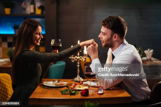 couple having romantic dinner in a restaurant - young couple date night wine stock pictures, royalty-free photos & images