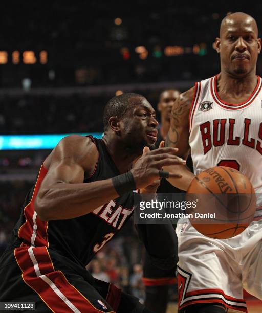 Dwyane Wade of the Miami Heat looses control of the ball as he moves against Keith Bogans of the Chicago Bulls at the United Center on February 24,...