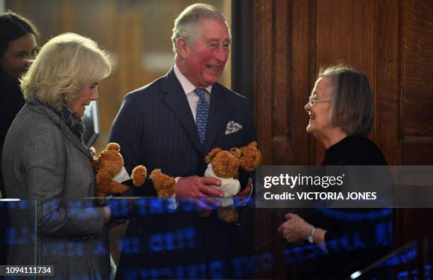 President of the Supreme Court, Baroness Brenda Hale , presents toys to Britain's Prince Charles, Prince of Wales and Britain's Camilla, Duchess of...