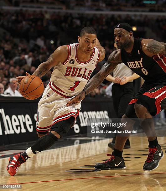 Derrick Rose of the Chicago Bulls drives against LeBron James of the Miami Heat at the United Center on February 24, 2011 in Chicago, Illinois. The...