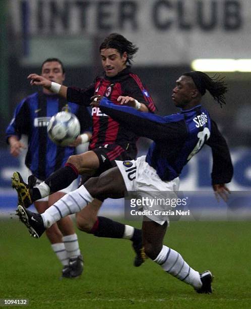Francesco Coco of Milan battles with Clarence Seedorf of Inter during the AC Milan v Inter Milan Serie A match played at the Guiseppe Meazza in...