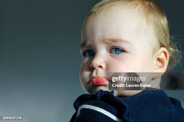 portrait of a sulking baby - trotzanfall stock-fotos und bilder