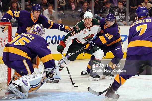 Eric Nystrom of the Minnesota Wild skates with the puck against Michal Handzus of the Los Angeles Kings at Staples Center on February 24, 2011 in Los...