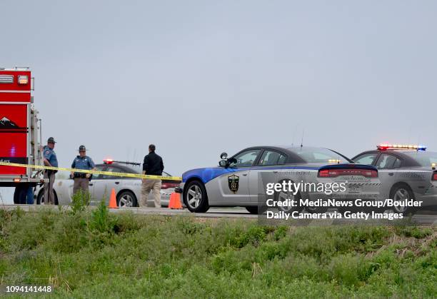 Colorado State Patrol, Weld County Sheriffs Deputies, Longmont Police and Mountain View Fire Rescue personnel are seen near Weld County Road 1 and...