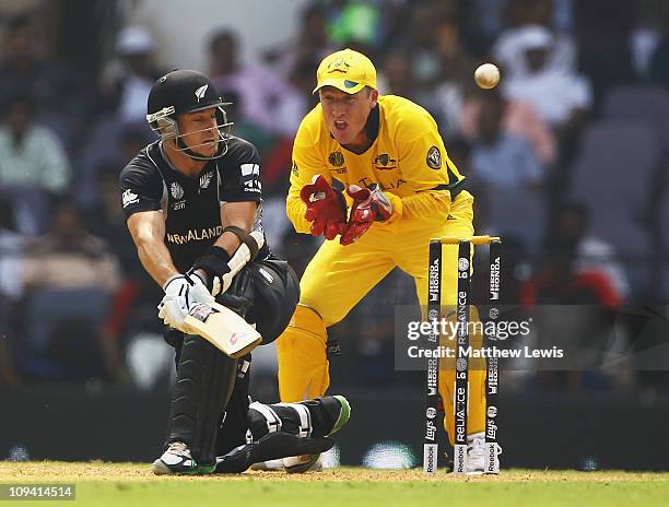 Brendon McCullum of New Zealand hits the ball towards the boundary, as Brad Haddin of Australia looks on during the 2011 ICC World Cup Group A match...