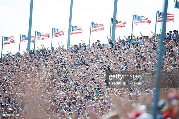 Daytona 500: Overall view of fans holding up three fingers during memorial for late driver of car Dale Earnhardt Sr. Before race at Daytona...