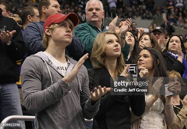 Singer Taylor Swift and actor Chord Overstreet attend an NHL hockey game between the Minnesota Wild and the Los Angeles Kings at Staples Center on...