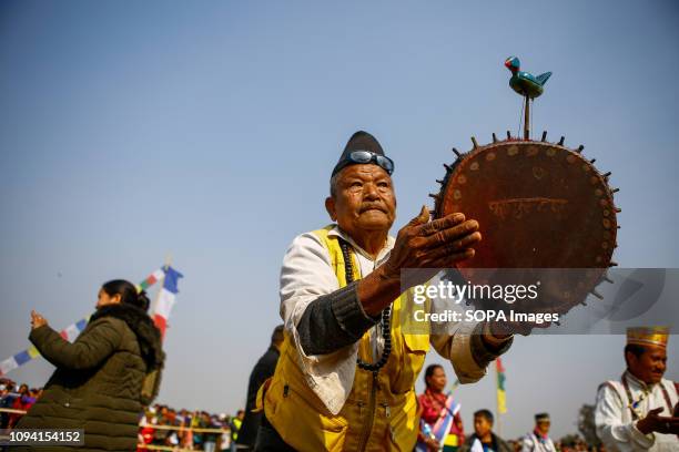 Man from Tamang community plays a traditional drum and dance as he attend the program to mark the Sonam Losar or Lunar New Year. Sonam Losar occurs...